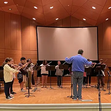 Dr. Giray conducts the LOU Youth symphony during rehearsals in Nutt Auditorium