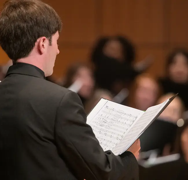 Man with open book of music