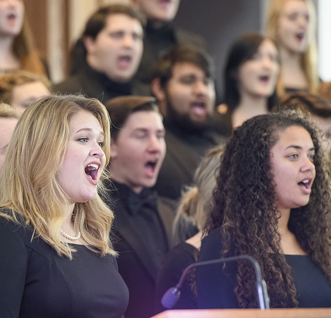 Two members of Concert Singers harmonize together during a concert