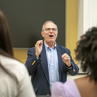 Dr. Donald Trott conducts his choir during practice