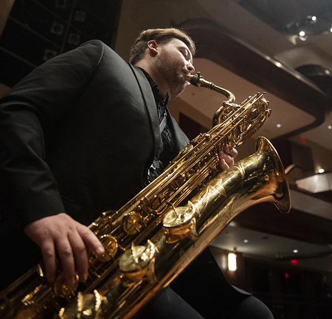 Student plays his instrument