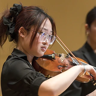 A student plays her instrument