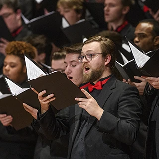 Close up of a choir member singing during a concert