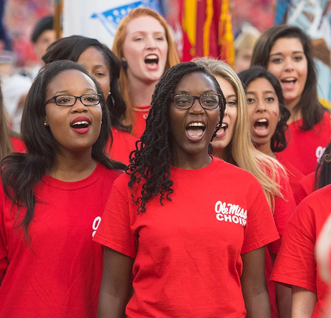 Women's glee choir during a performance during a football game