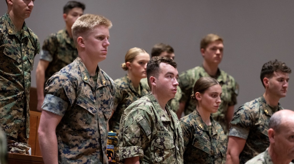 image of students in uniforms standing at attention in a classroom