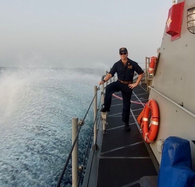 image of student standing on a warship with the waves showing