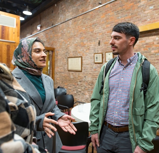 image of a student and alumnus standing and talking together