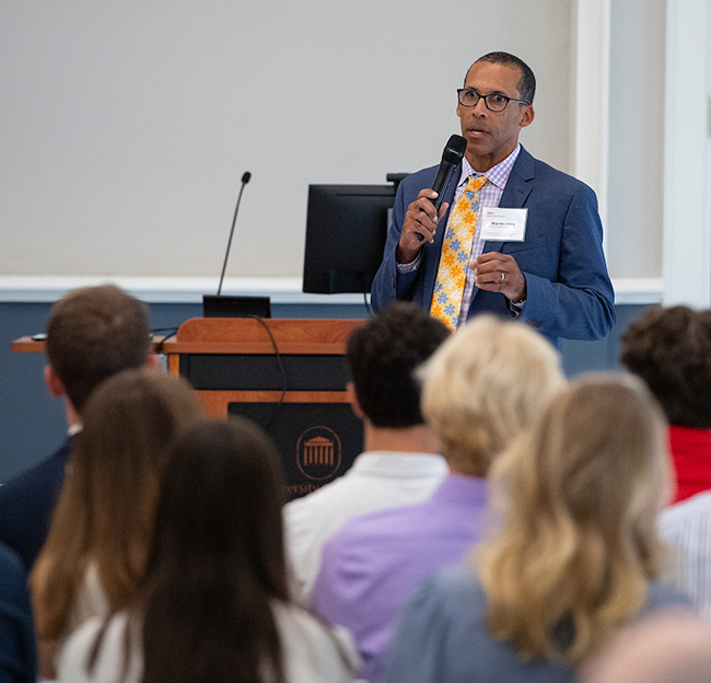 Marvin King speaking in front of a crowd