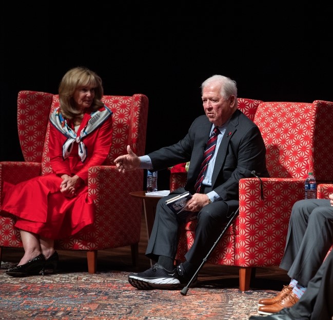 image of Haley Barbour gesturing and talking while seated on stage with others