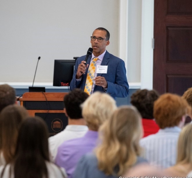 Marvin King speaking to a crowd of people