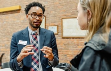 image of an alum talking with a student