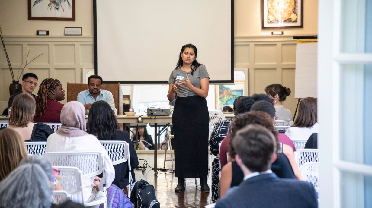 A woman speaks in front of a crowd at the Delta Regional Forum.