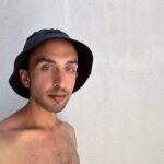 portrait of Charlie Pappas against white background in hat