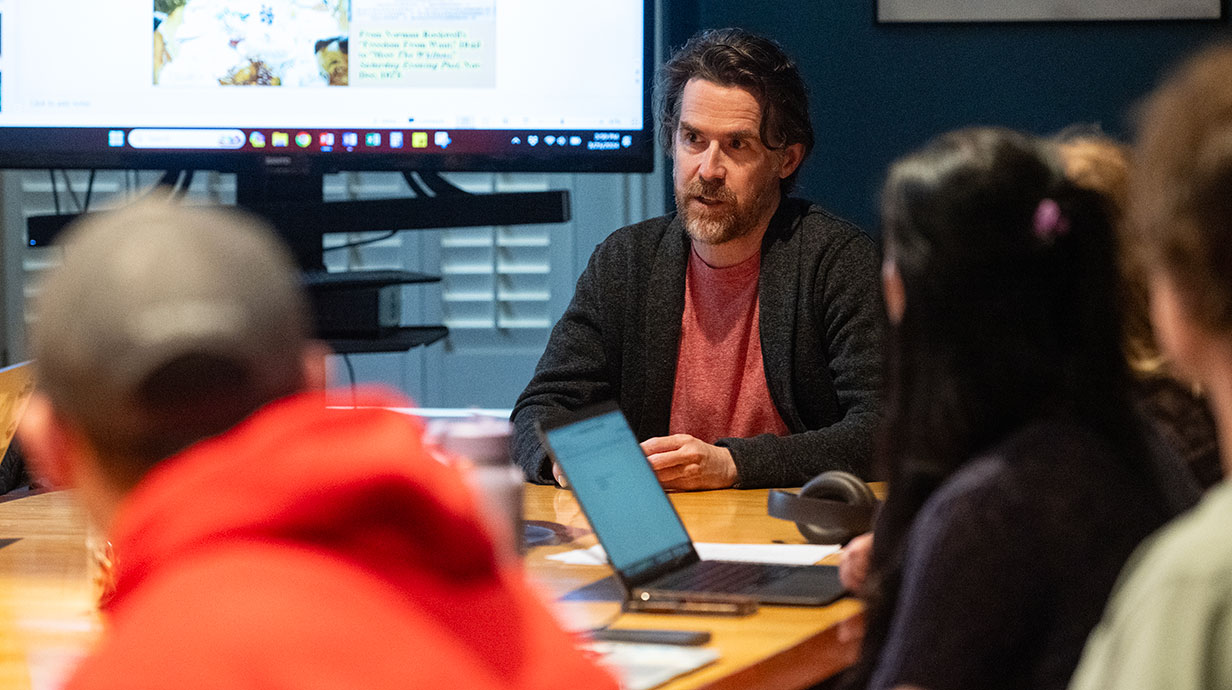 Teach talking to students at table