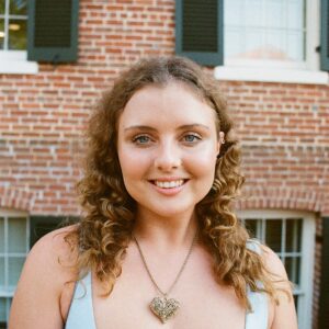 Ellis Farese standing in front of brick wall