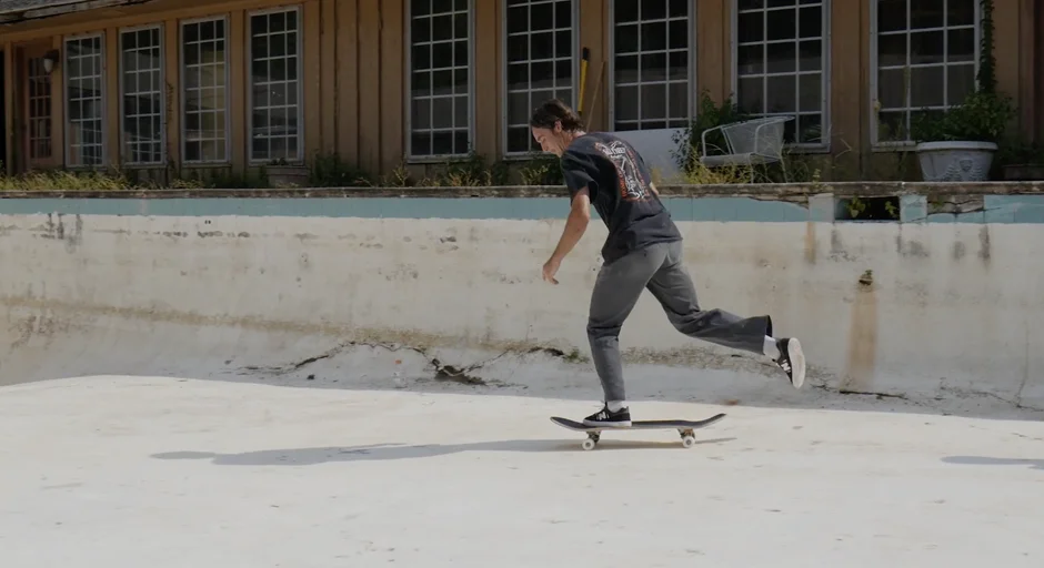 person on a skateboard in concrete bowl