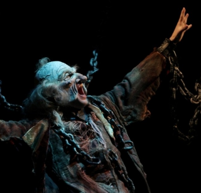image of an actor in costume and mask for the Ghost in a Christmas Carol