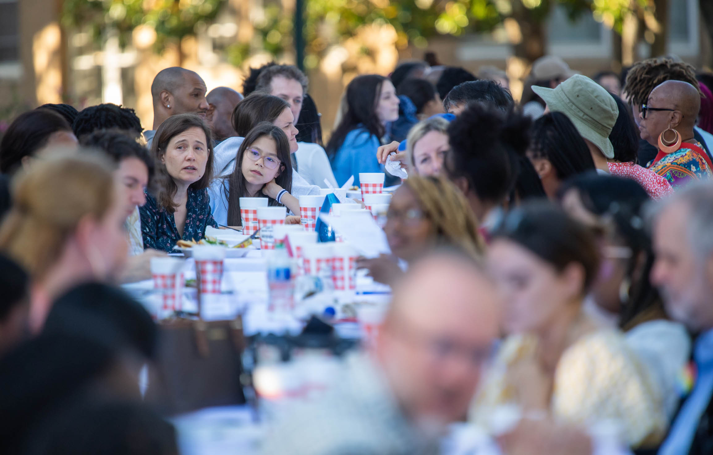 people sitting at a long table having a conversation