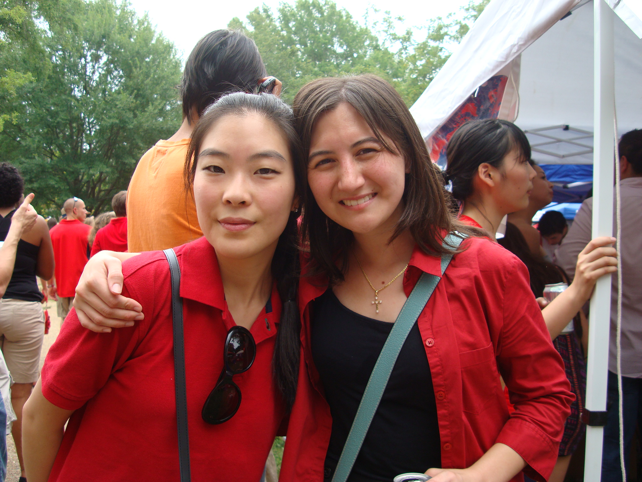 Two female international smile while attending the UM international  football game tailgate