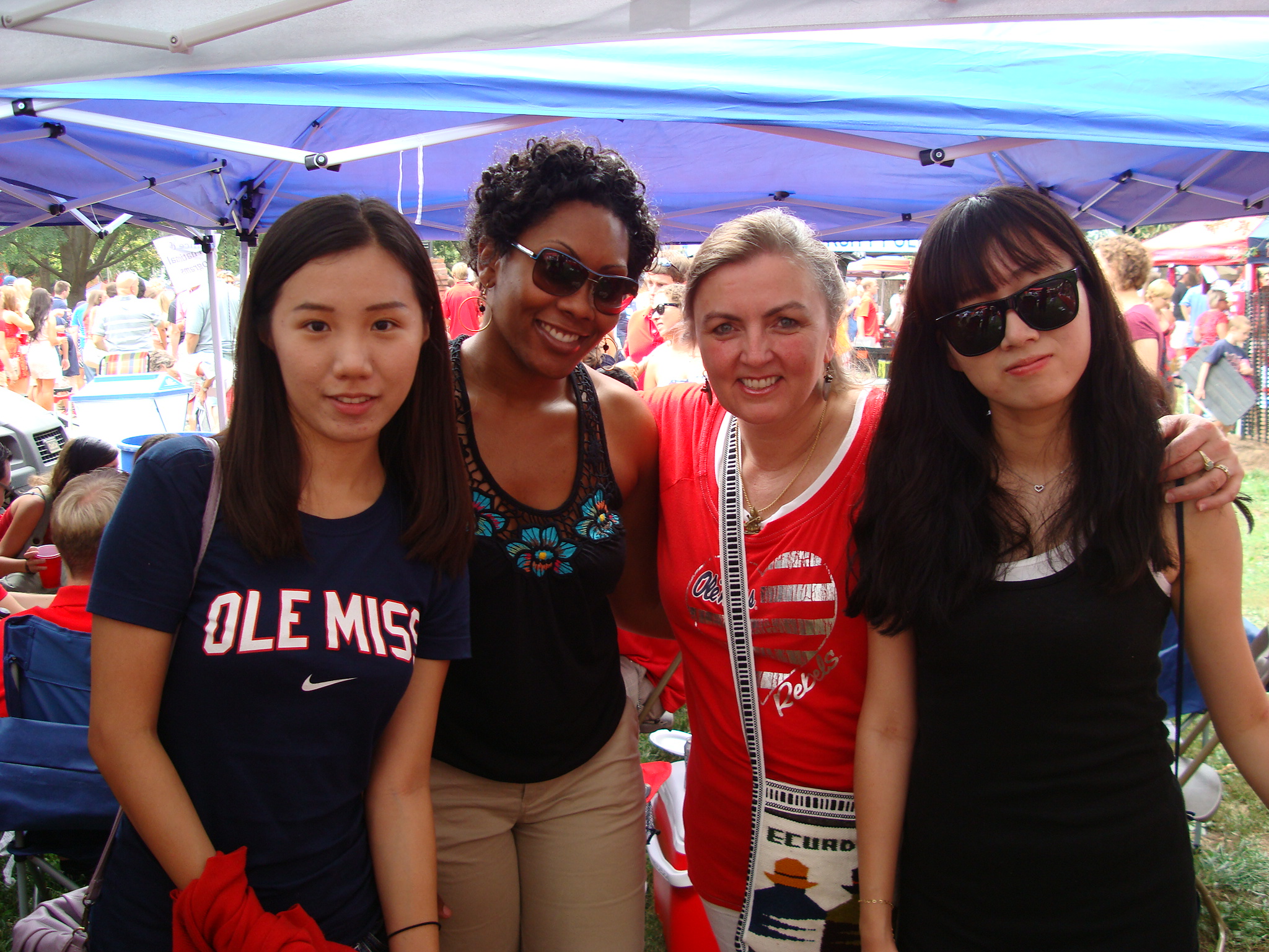 International student pose with ISSS staff during UM football game tailgate