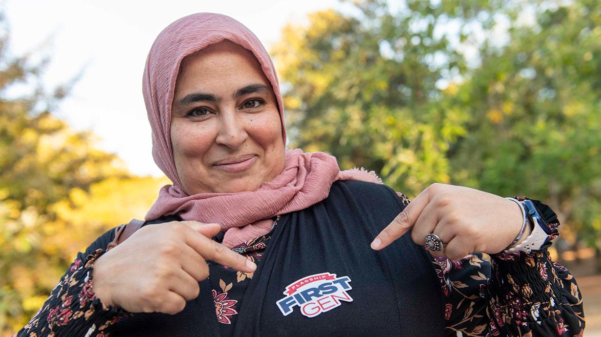 A student points to a Flagship First-Gen sticker during an event celebrating first generation students.