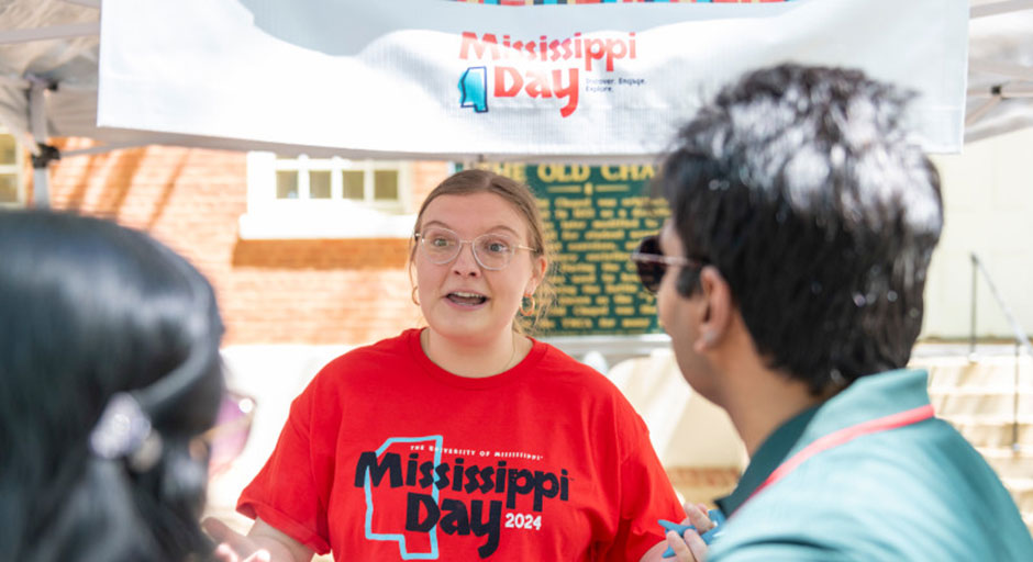 A Mississippi Day volunteer shares more with participants during the event in 2024