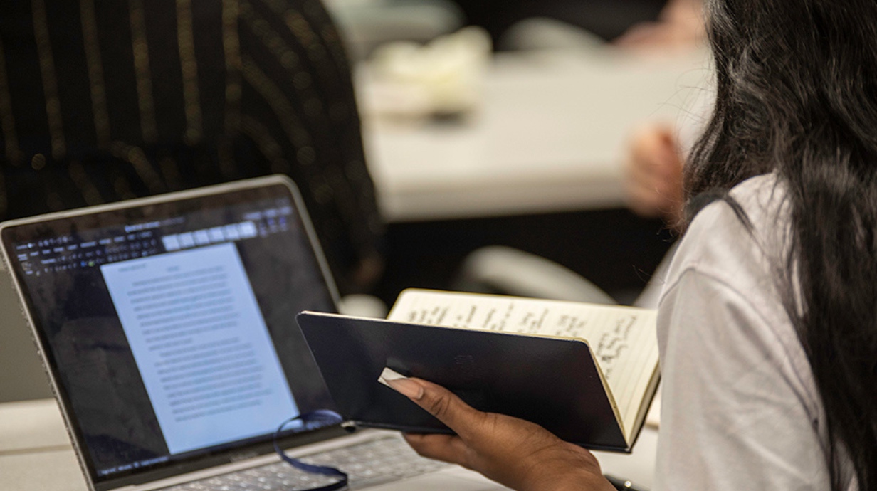 A University of Mississippi student takes notes during a seminar.