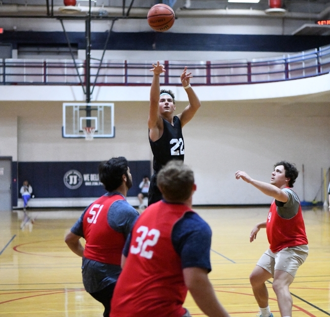 Two teams of student playing intramural basketball. 