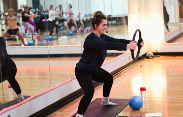 Group fitness instructor leading class.