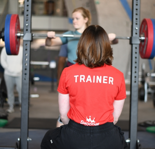 Personal trainer working with a client.