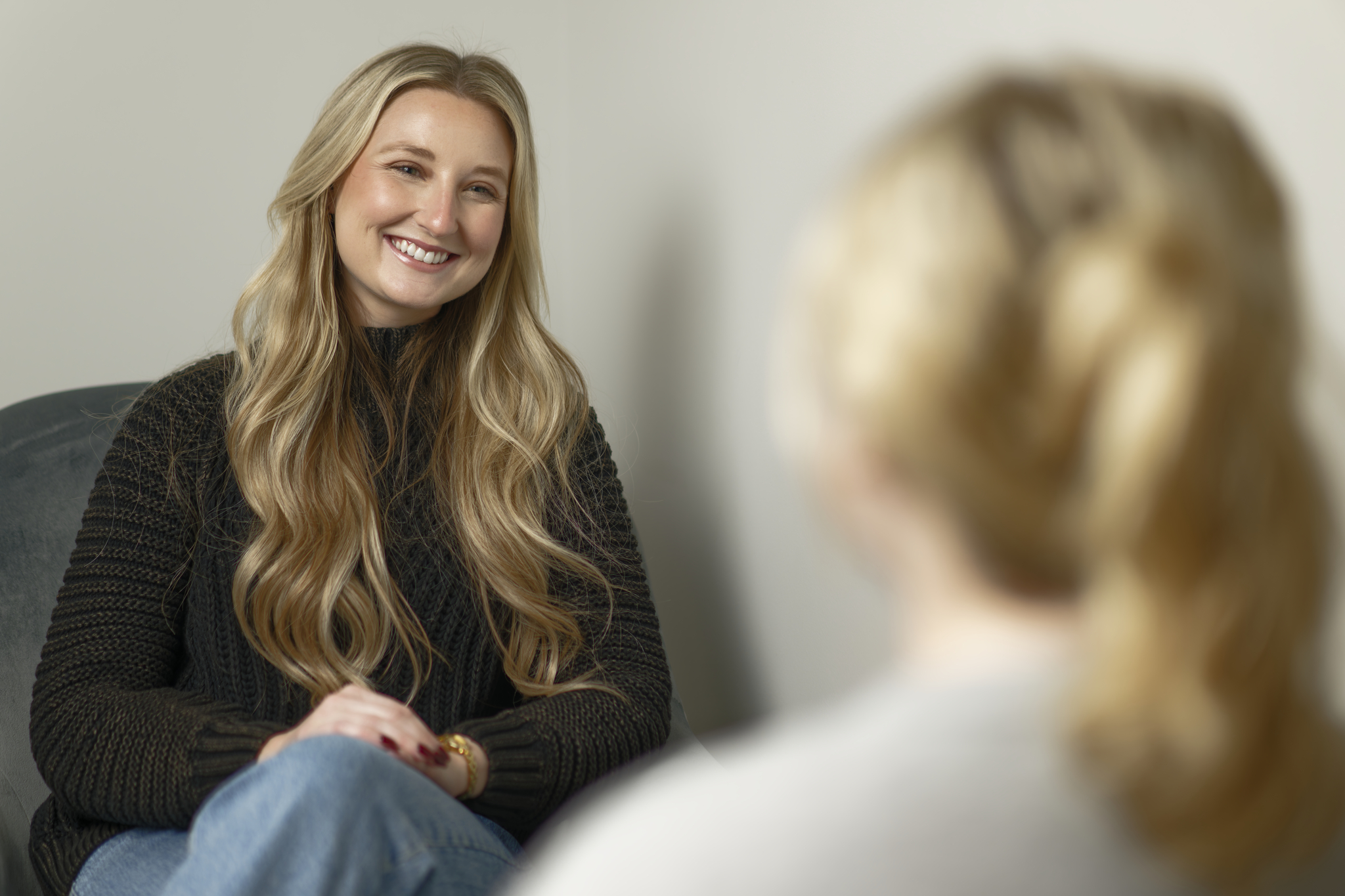 person smiling and talking to someone
