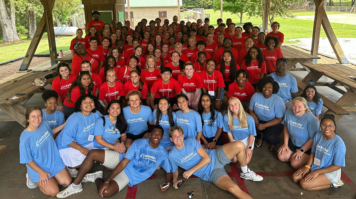 students posing for a group photo with luckyday shirts on