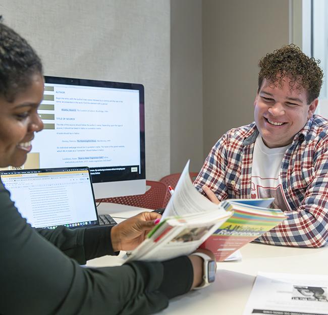 writing center two people review papers