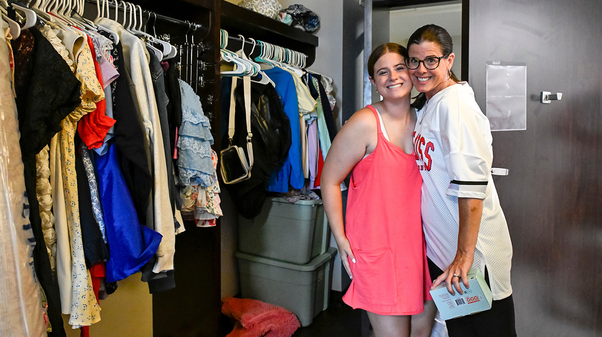 mother and daughter posing in a dorm room