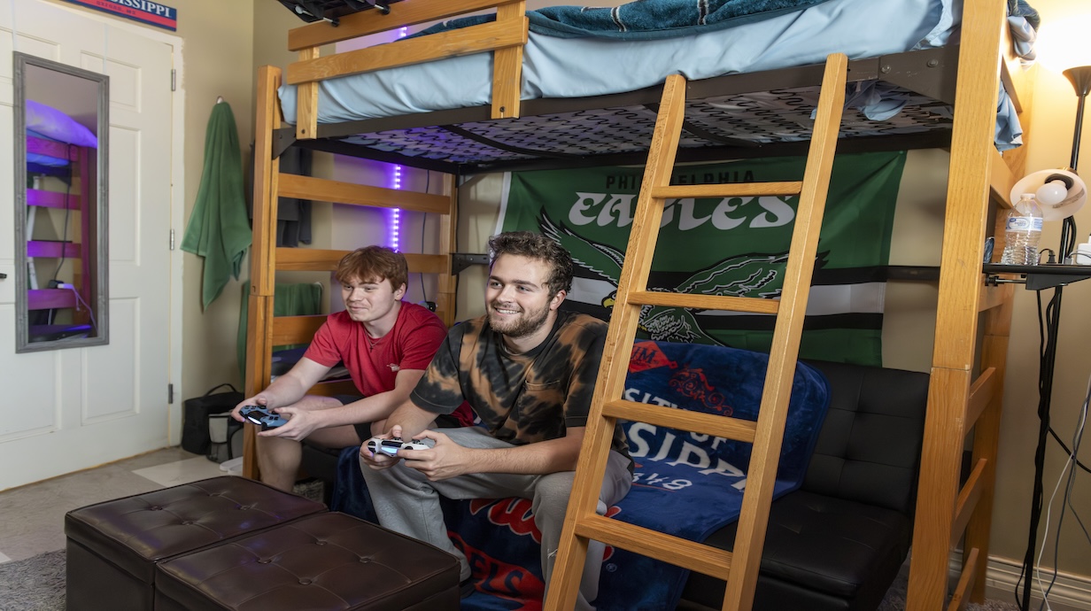 Two male students playing video games