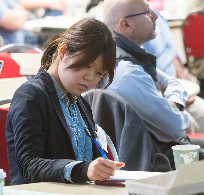 student looking down reading a book