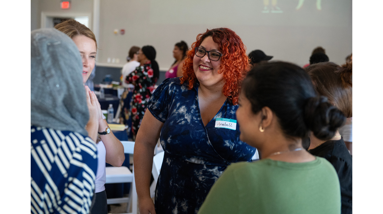 Graduate students chatting with one another at Graduate Teaching Orientation