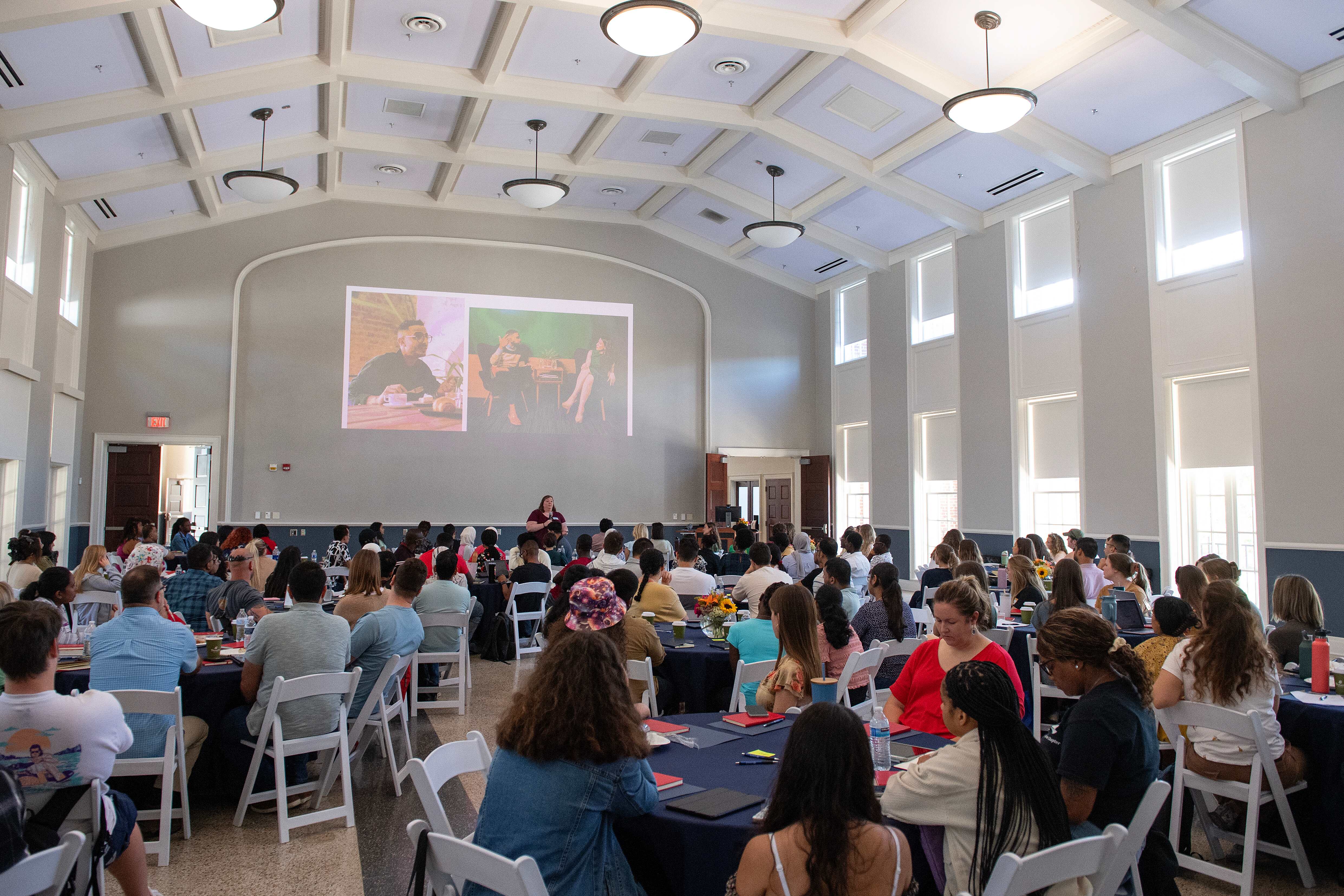 A room full of students sitting at tables at Graduate Teaching Orientation