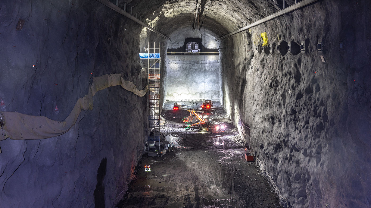 Heavy machinery works in a giant underground cavern.