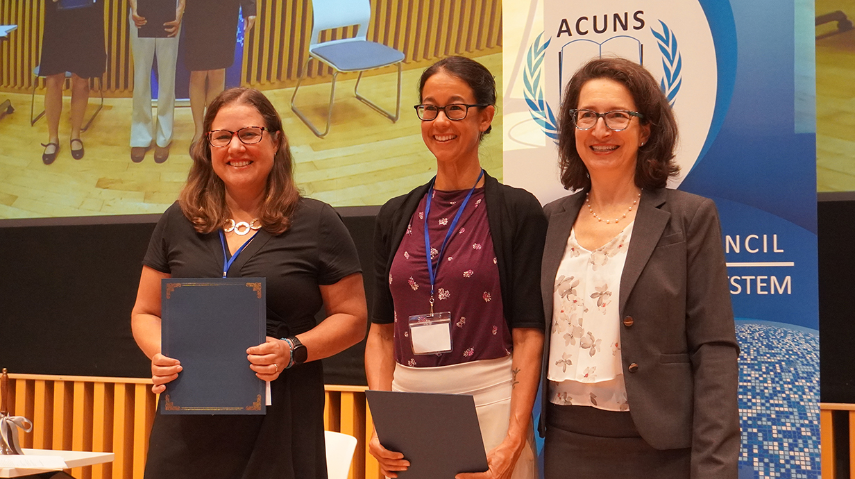 Three women at UN accepting an award