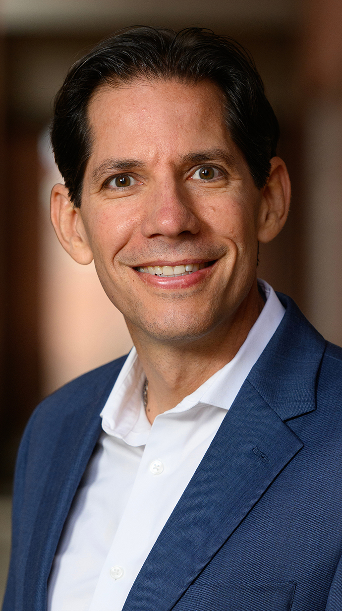 Portrait of a man wearing a blue blazer.