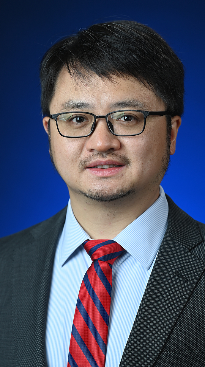 Headshot of a man wearing a suit.