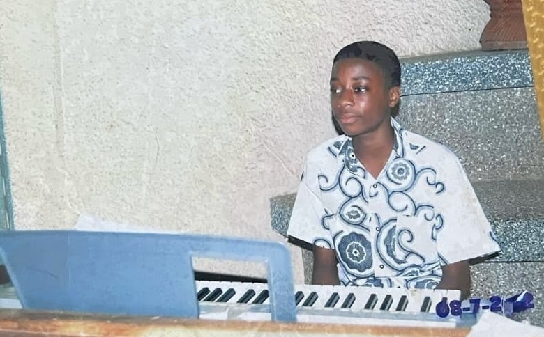 An image of Ransford Addae at a piano when he was younger.