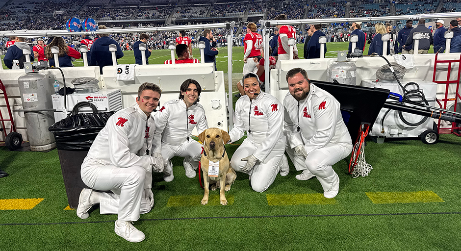 Drum majors with a yellow lab