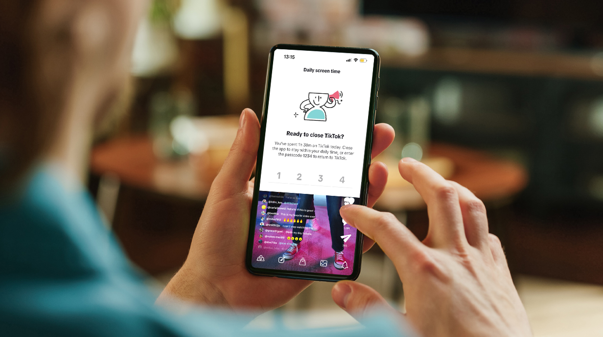 A person looks at a smartphone with a message asking 'Are you ready to close TikTok?'
