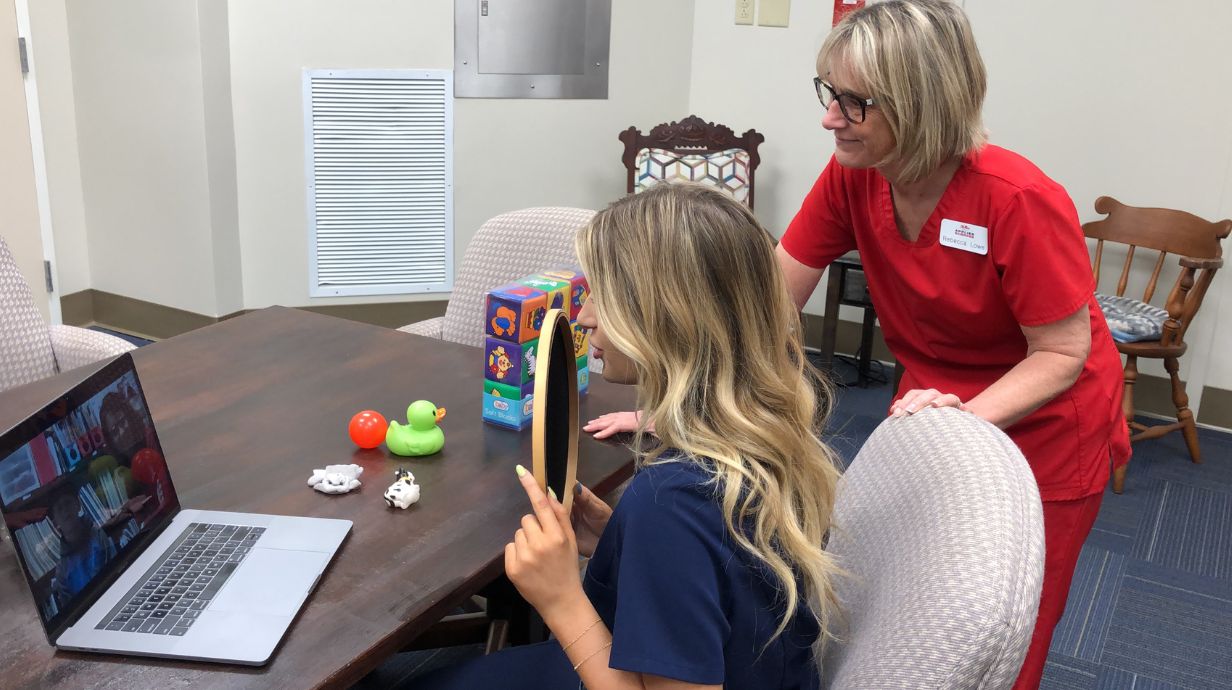 Bachelor of Science in Communication Sciences and Disorders student engaging in therapy with patient.