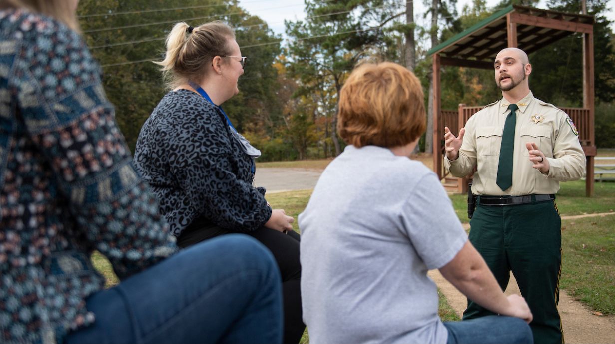 Master in Criminal Justice Students discuss topics in a criminal justice classroom.