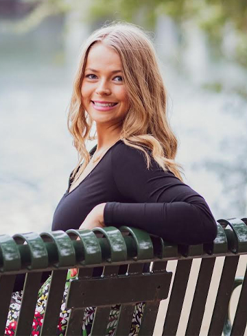 Photo of Clair Sahs sitting on a bench