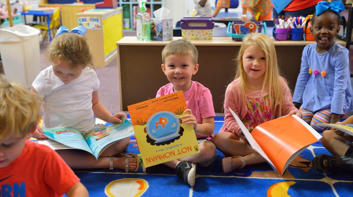 Four children reading books.