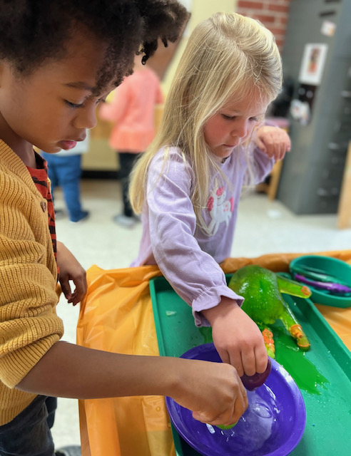 Two children complete an experiment.